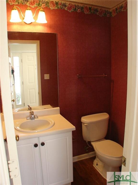 Powder room has wood look vinyl flooring