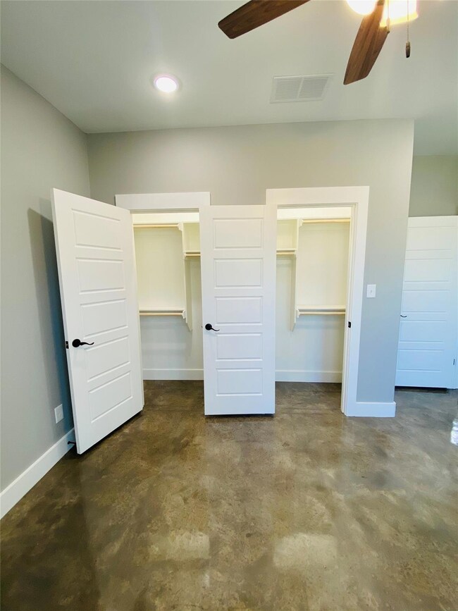 Unfurnished bedroom featuring ceiling fan, a close