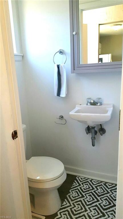 Half Bath on main floor with new toilet, new flooring and fresh paint