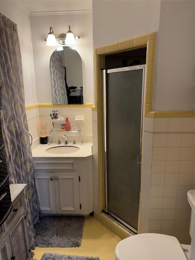 Bathroom with vanity, toilet, a shower with shower