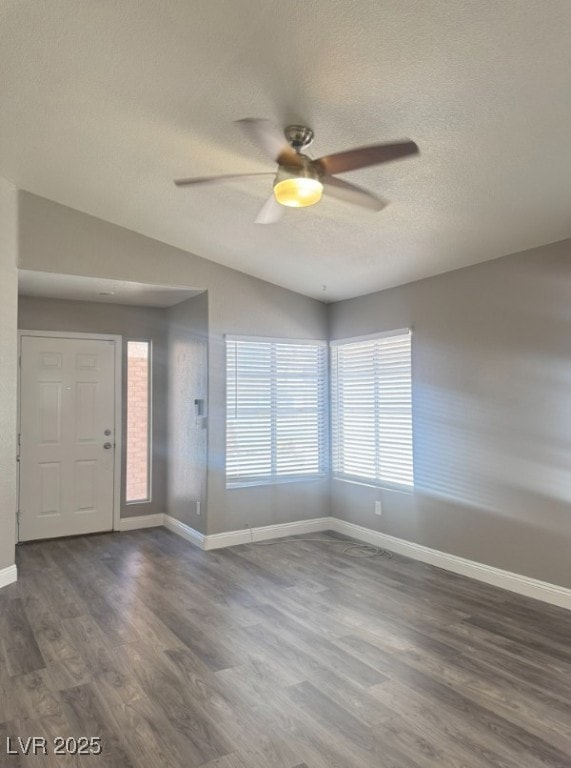 Entryway featuring vaulted ceiling, dark wood-style flooring, a textured ceiling, and a ceiling fan