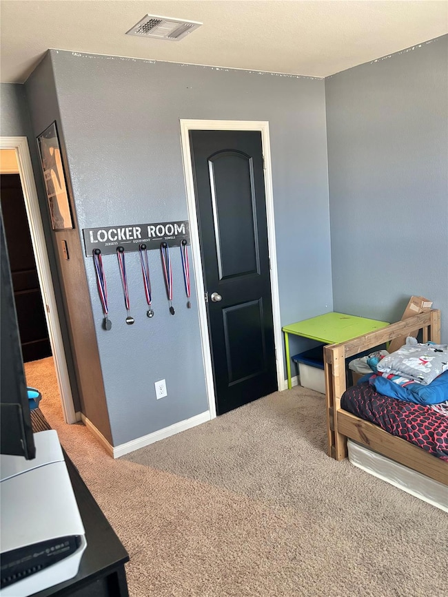 Bedroom with carpet and baseboards