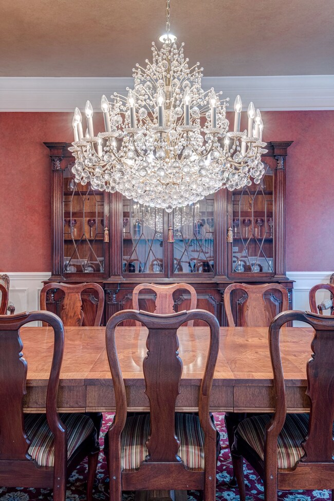 Take a moment to appreciate this decadent crystal chandelier. Adorned with an elaborate ceiling medallion, it’s just one example of the opulent fixtures and finishes found throughout the home.