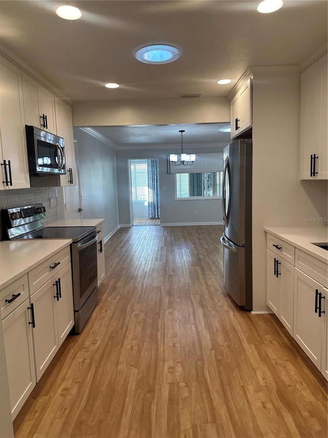 Kitchen looking to Dining Room and out to the Florida Room