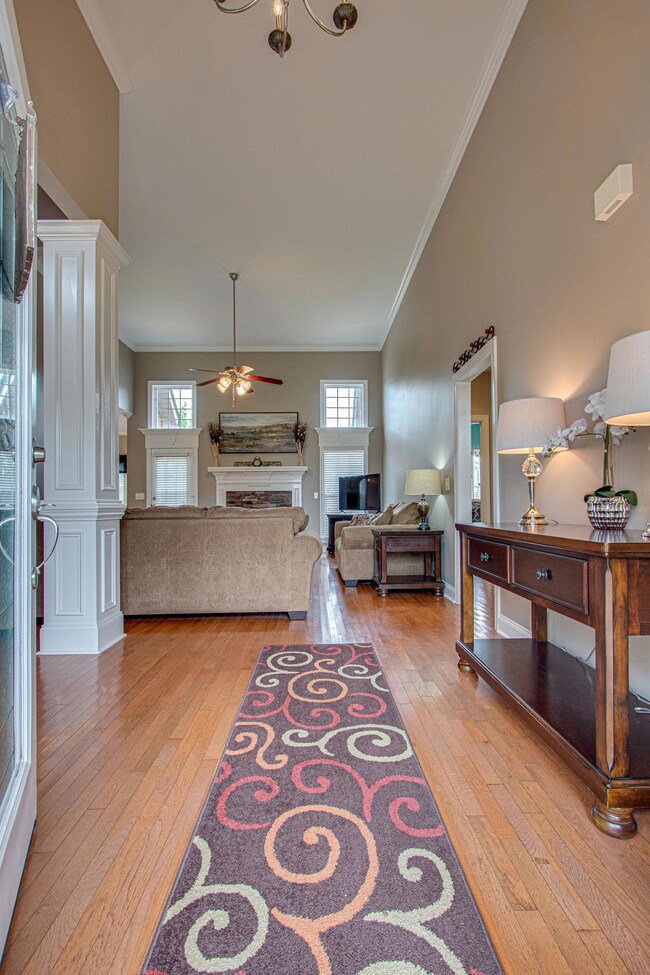 Soaring ceilings, gleaming hardwood floors and fresh paint greet you as you enter the home