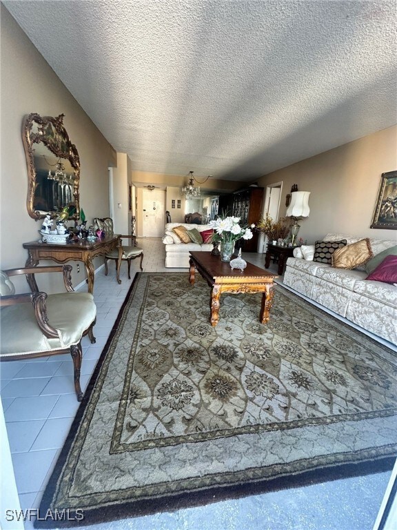 Living room with tile patterned floors, lofted cei