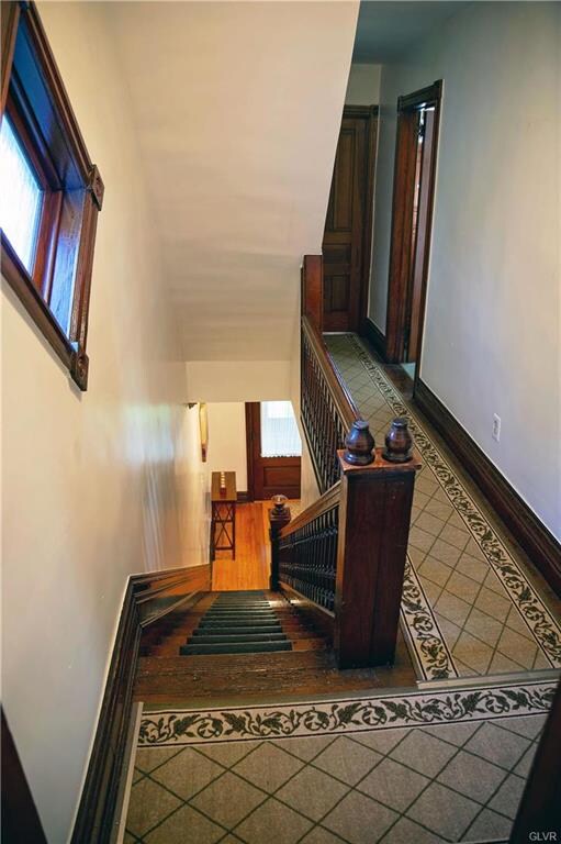 Stairway to second floor with original woodwork ar