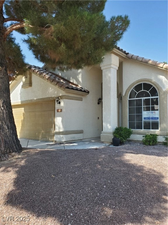 View of front of property featuring a tile roof, a