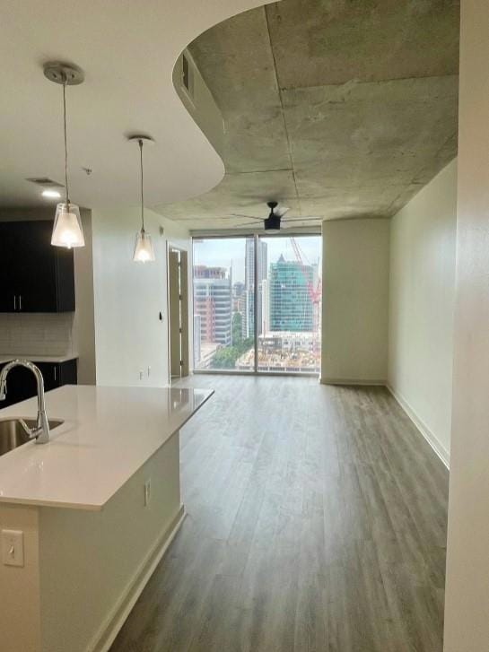 Kitchen with ceiling fan, sink, hanging light fixt