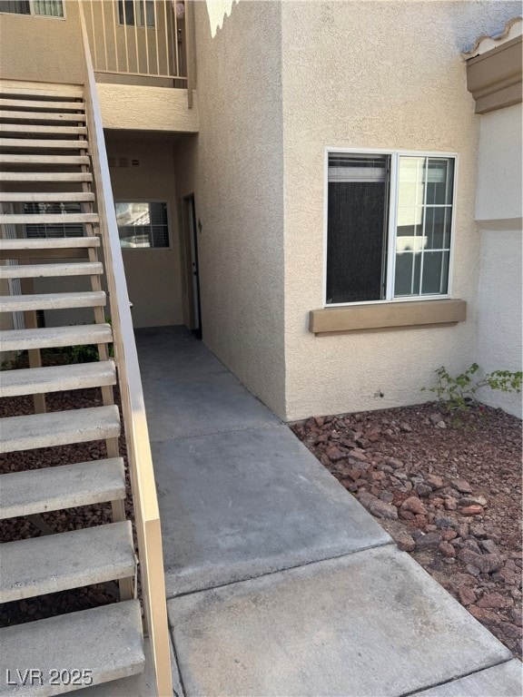 View of exterior entry with stucco siding