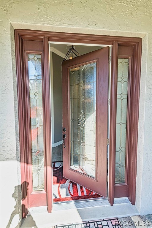 The covered entrance with leaded glass door is a w