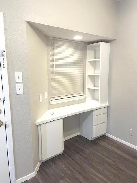 Unfurnished office featuring built in study area,