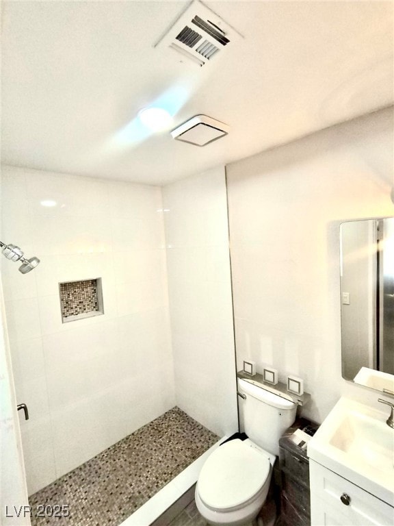 Bathroom with a stall shower, toilet, and vanity