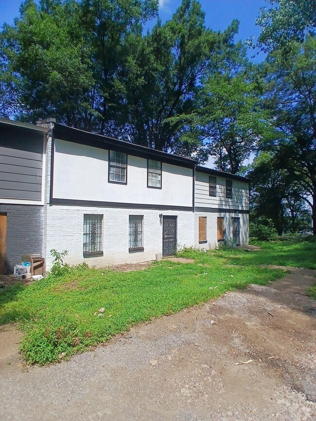 View of home's exterior featuring brick siding and a yard