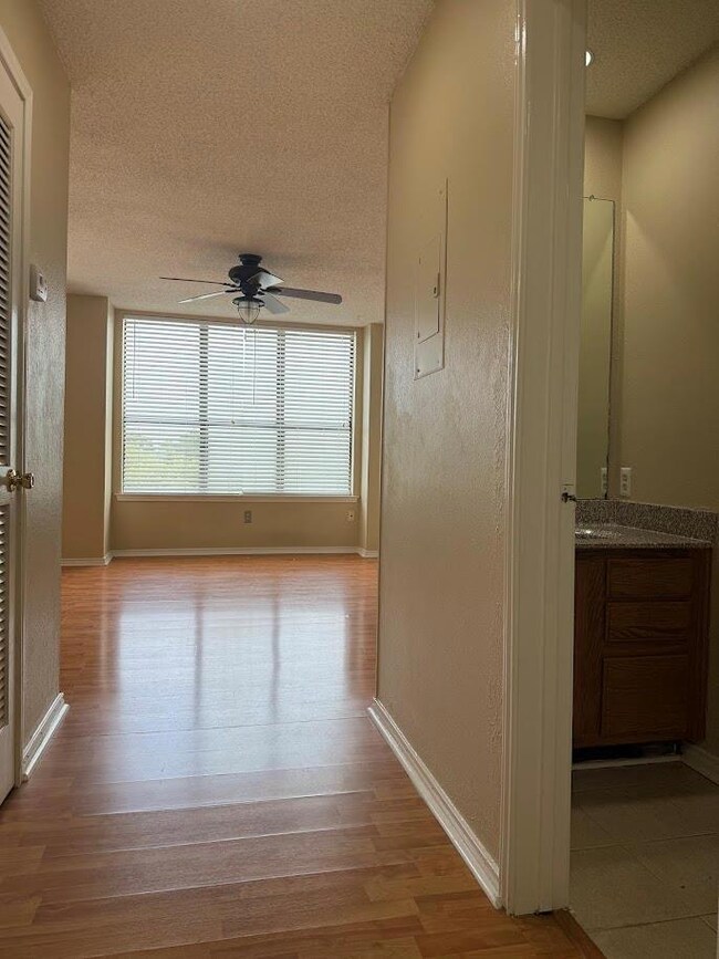 Hall featuring a textured ceiling and wood finish