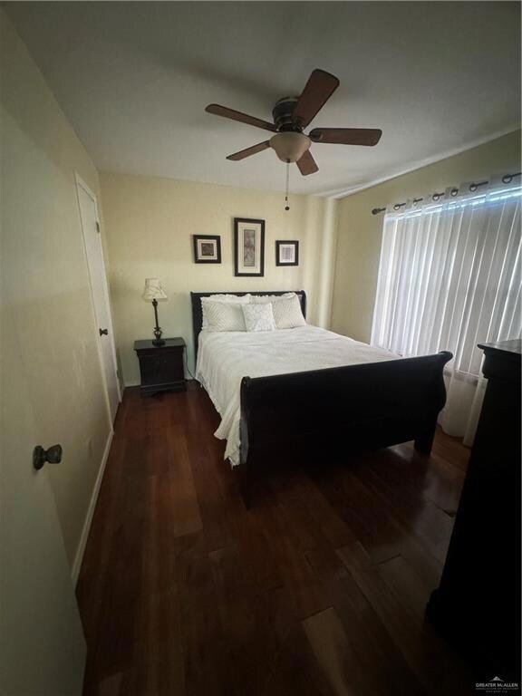Carpeted bedroom featuring ceiling fan