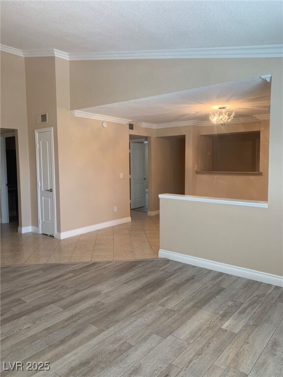 Empty room with visible vents, wood finished floor