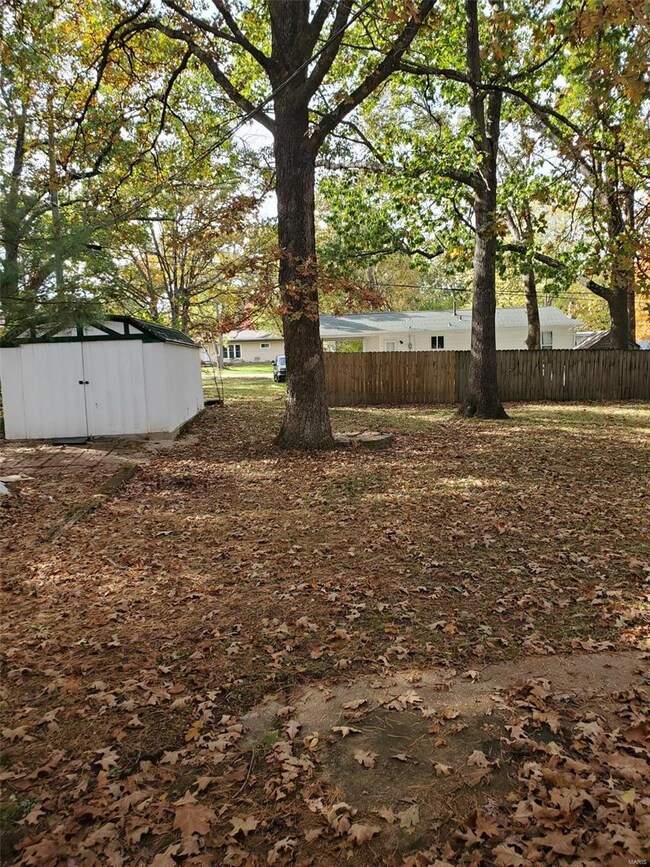 BACK VIEW TOWARD METAL DETACHED GARAGE
