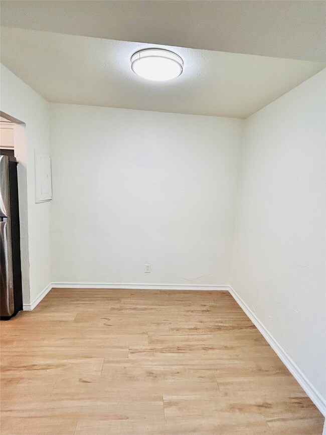 Spare room with light wood-style flooring and baseboards