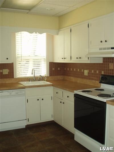 Well organized working kitchen with tile backsplas