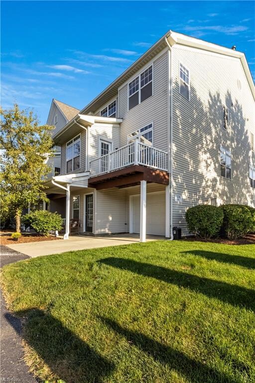 Rear view of house with a yard and wooden deck