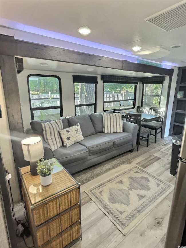 Living room with wood-type flooring