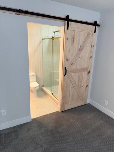 Bathroom featuring toilet, a stall shower, and bas