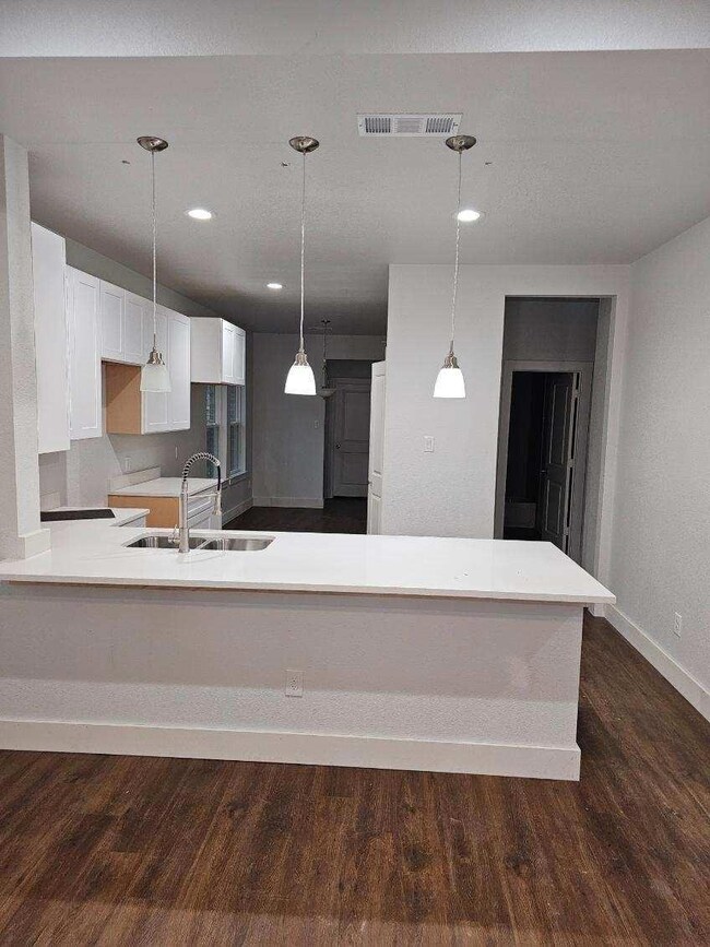 Kitchen featuring sink, hanging light fixtures, ki