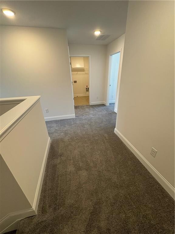Unfurnished room with a tray ceiling, light colore