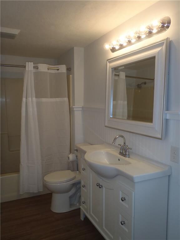 Master bath with new drywall, bead board, lighting, commode, sink & cabinet!