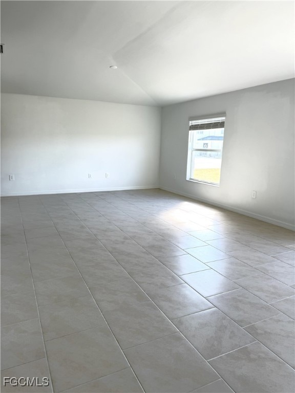 Empty room featuring light tile patterned flooring