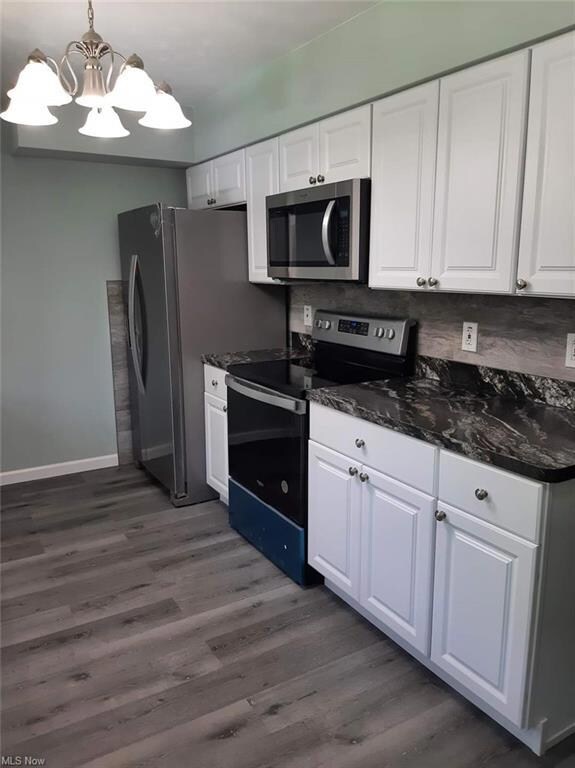 Kitchen featuring dark hardwood flooring, stainles
