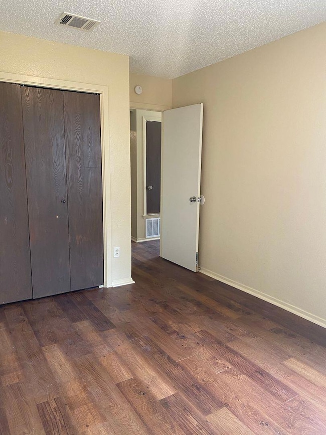 Unfurnished bedroom featuring a textured ceiling,