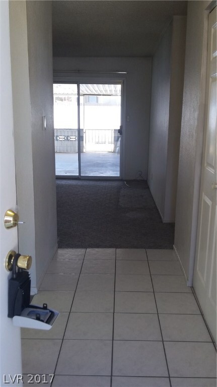 Entry way with coat closet looking into the family
