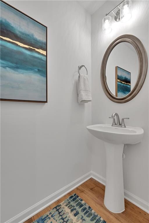 Bathroom featuring wood finished floors and baseboards
