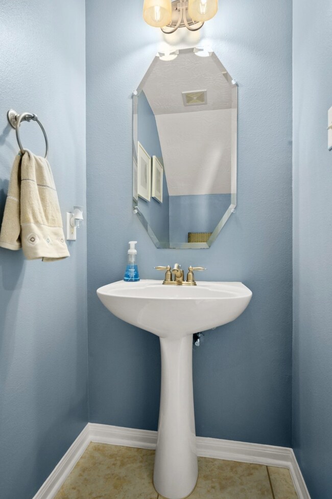 A charming half bath is conveniently located directly off the foyer.