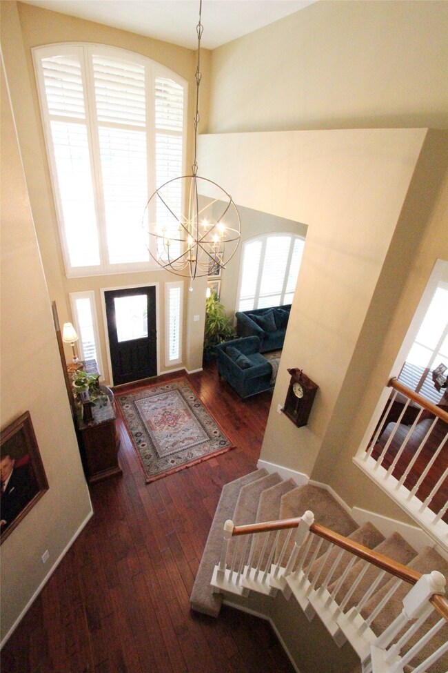Huge windows let in lots of natural light to add to the beauty of this home. Notice the plantation shutters!