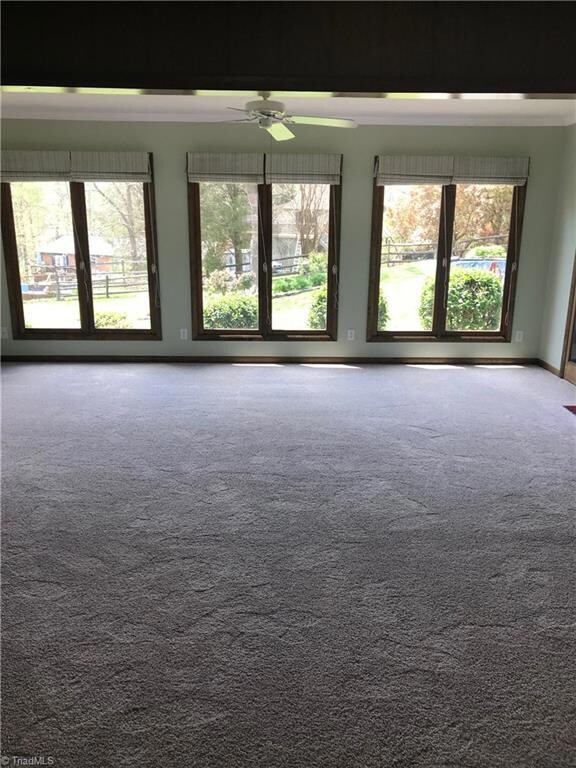 Large Sunroom with view of the back yard, pool, and patio.