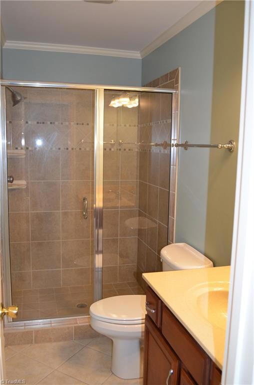 Downstairs bathroom with tile surround and glass door.