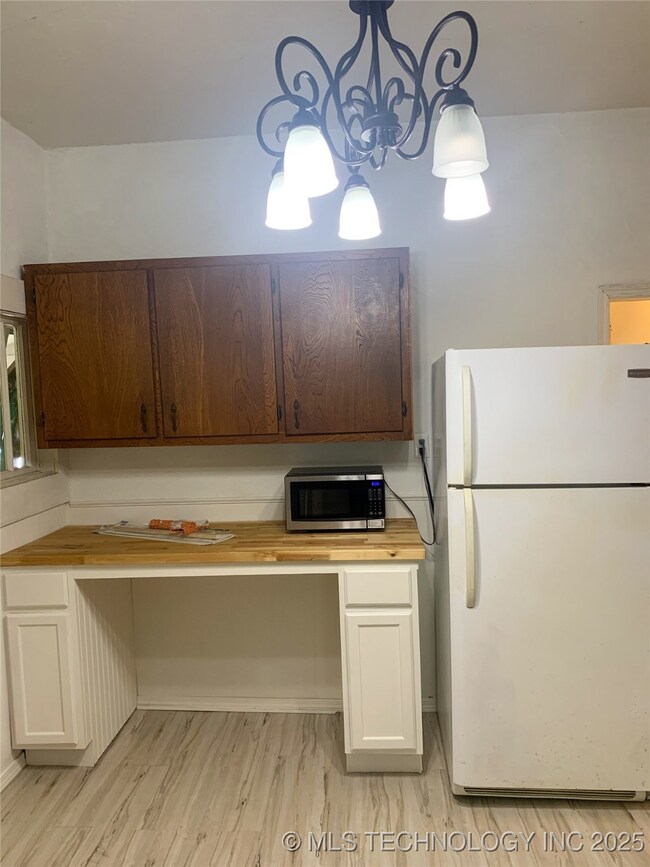 Kitchen with freestanding refrigerator, stainless