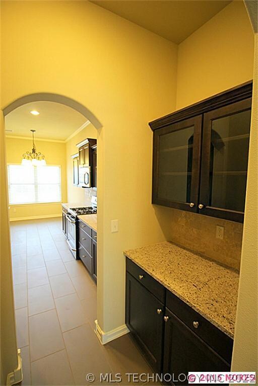 Butlers pantry features granite with glass cabinet