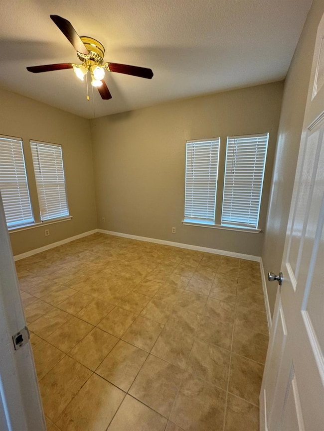 Spare room with light tile patterned floors, base