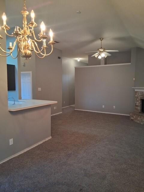 Unfurnished living room featuring baseboards, a fi