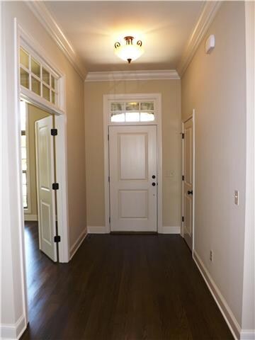 The beautiful foyer leads to the great room with a study/BR located to the right.