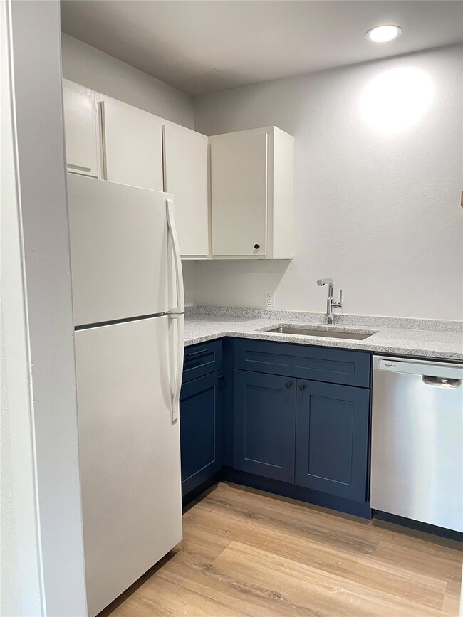 Kitchen featuring freestanding refrigerator, dish