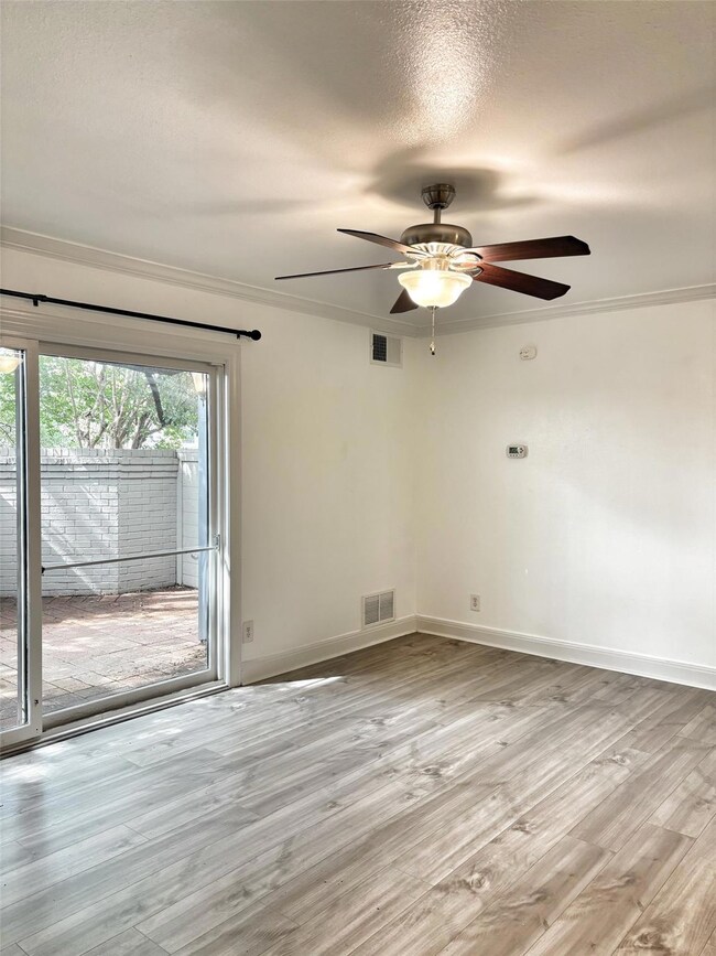 Empty room featuring ornamental molding, light wo
