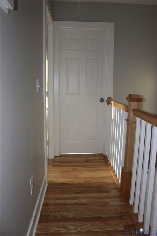 Hallway with wood finished floors and baseboards