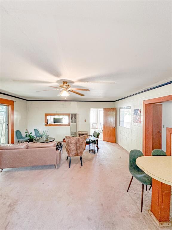 Living room featuring light carpet and ceiling fan