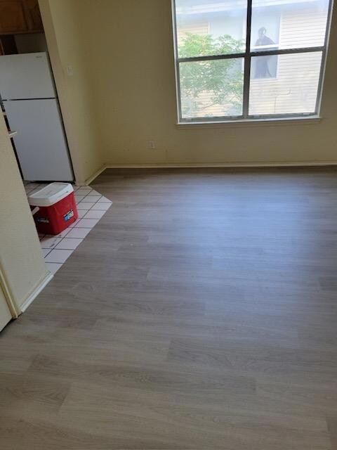 Unfurnished dining area with light wood-style flo