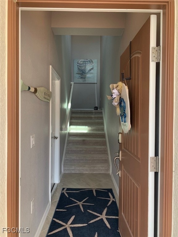 Hallway featuring light tile patterned flooring